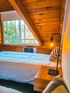 Ein Bett oder Betten in einem Zimmer der Unterkunft Cabaña Oasis