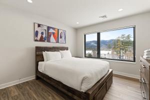 a bedroom with a large bed and a large window at Upstate NY Lake House in Lake George