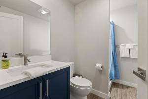 uma casa de banho com um lavatório branco e um WC. em Upstate NY Lake House em Lake George