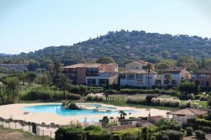 ein Resort mit einem großen Pool vor einem Berg in der Unterkunft Appartement cosy climatisé à 100m des plages in Gassin