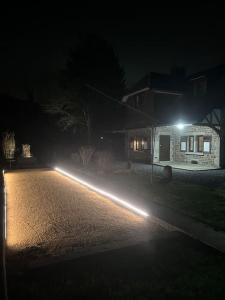 a house with lights on the street at night at « L’Écluse Simon » in Tilff