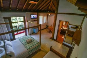 uma vista aérea de um quarto com uma cama e um espelho em Thai Pousada em Ubatuba