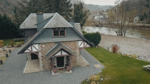 an overhead view of a house on a river at « L’Écluse Simon » in Tilff