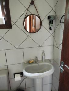 un bagno con lavandino e specchio di Recanto do Sossego- Espaço Jean a Santa Cruz do Sul Altre 19 foto