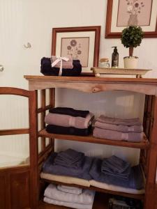 a wooden shelf with towels on it in a bathroom at The Barn At Slick Rock in Hendersonville