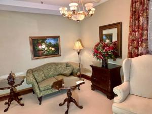 a living room with a couch and a chair at The Port Hotel in Port Washington