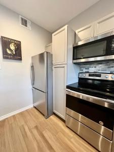 a kitchen with a stainless steel refrigerator and a microwave at Modern 2 bedroom house w/backyard @La Cantera in San Antonio