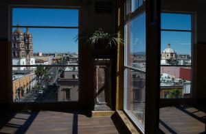 a view of a city from an open window at Hotel Casablanca in Durango