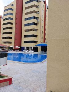 a swimming pool in front of two tall buildings at Cobertura Parque das Aguas in Caldas Novas