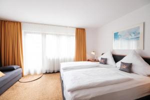 Rúm í herbergi á Hotel Flora Möhringen