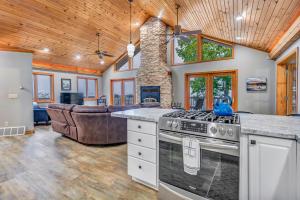 a kitchen with a stove and a living room at Majestic View Sleeps 10 Hot Tub in De Soto