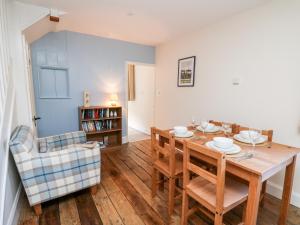 a dining room with a table and a chair at Railway Station Cottage in Llandrindod Wells