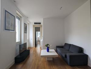 a living room with a couch and a table at Vittore Rooms & Apartment in Milan