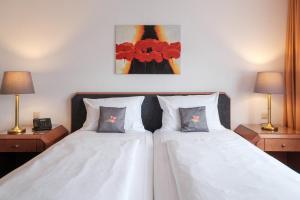 Rúm í herbergi á Hotel Flora Möhringen