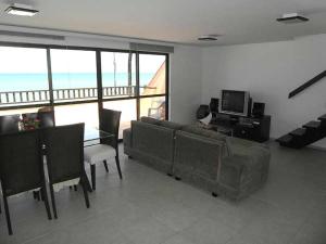 a living room with a couch and a table at Hotel Oceon in Caucaia