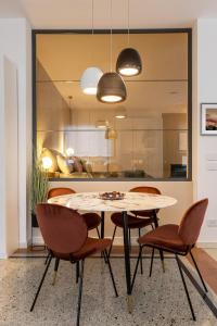 a dining room with a table and chairs at TRENTINO LODGE Piazza Municipio in Strigno