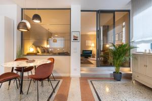 a dining room with a table and chairs and a bedroom at TRENTINO LODGE Piazza Municipio in Strigno