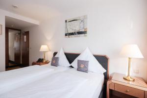 Rúm í herbergi á Hotel Flora Möhringen