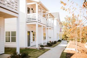 a building with white siding and a sidewalk at Artists Retreat - Dt Athens, Uga, Classic Center in Athens