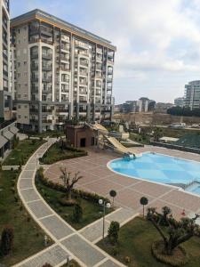 an apartment complex with a swimming pool and a building at Emerald Paradise Apartment in Avsallar