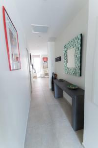un pasillo con una mesa y un espejo en la pared en Alceste 2-bedroom Apartment Prime Location Near Beach and Palais en Cannes