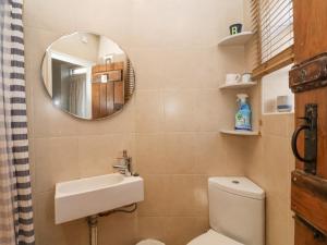 a bathroom with a sink and a toilet and a mirror at Rosemary Cottage, Aldeburgh in Aldeburgh +11 photos