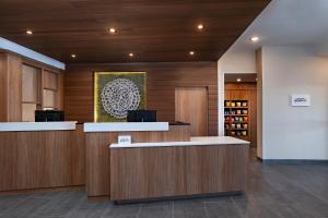 a lobby of a hotel with a reception desk and a painting at Fairfield by Marriott Inn & Suites Hillsboro in Hillsboro