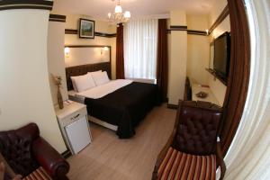 Säng eller sängar i ett rum på Gloria Tibi Hotel