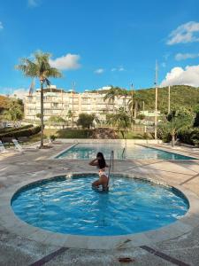 a woman is sitting in a small pool of water at Tropical Villa Ocean View in Maunabo