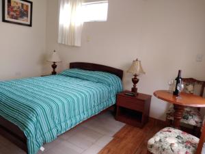 En eller flere senger på et rom på Central Trujillo