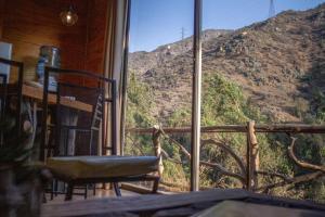 a room with a view of a mountain through a window at Casa Ñilhue, Camino a la Farellones in Santiago