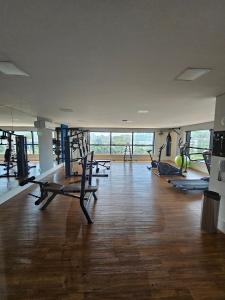 a gym with several treadmills and pilates equipment at Edifício Infinite in Ribeirão Preto