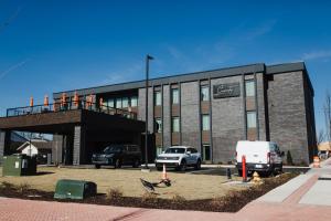 a building with cars parked in front of it at The Carpentry Hotel in Dalton