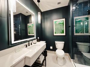 a bathroom with a toilet and a sink and a shower at The Carpentry Hotel in Dalton