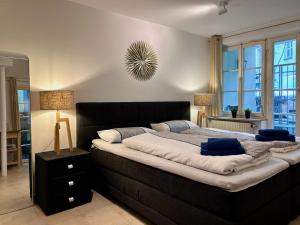 a bedroom with a large bed with two blue pillows at Ferienapartment Eva - gemütlich und zentral auf der historischen Insel Lindau in Lindau