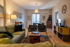 a living room with a couch and a table at La Paperella Blu Apartment in Termini Imerese
