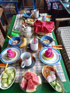 a table with plates of food and fruit on it at Los Aventureros in Samaipata