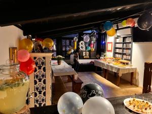 a party with balloons and a table with food and drinks at Blaje in Breaza de Jos