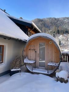 a round building with a round door in the snow at Apartment Krämerhaus Annaberg, Dachstein West in Annaberg im Lammertal