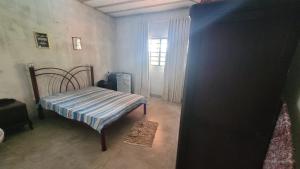 1 dormitorio con 1 cama y ventana en una habitación en Pérola do Sol - Esmeraldas MG, en Melo Viana