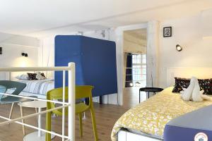 a room with a bed and a table and chairs at Loft de l'Artiste - Parking - Standing in Rouen