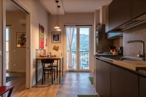 a kitchen with a counter and a table with a view at La Paperella Blu Apartment in Termini Imerese