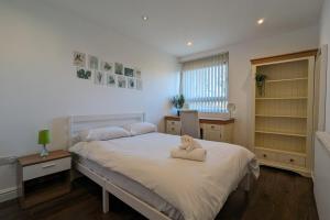 a bedroom with a bed with a towel on it at Fantastic Central 2DB Apt in Hulme in Manchester