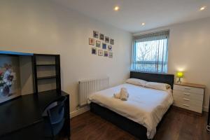 a bedroom with a bed with a teddy bear on it at Fantastic Central 2DB Apt in Hulme in Manchester