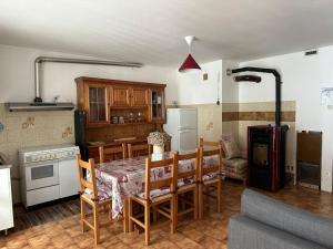 a kitchen and dining room with a table and chairs at Maison Moioli - Appartamento 3 in Piamprato