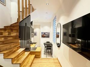 a staircase in a house with wooden floors at Triplex proche de Paris-Bercy in Saint-Maurice