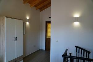 a hallway with a white cabinet and a staircase at Oceanis apartment in Symi