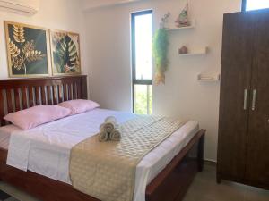 a bedroom with a bed with two pairs of shoes on it at Flat 402 Centro Porto Galinhas in Porto De Galinhas +37 photos