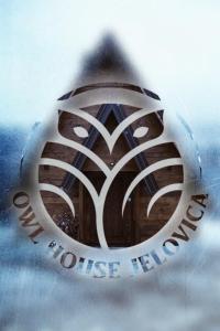 a close up of a logo on the side of a building at Owl House Jelovica in Berane