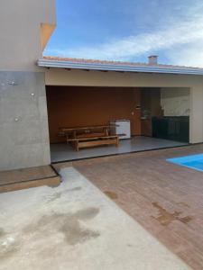 a building with a bench on the side of it at CASA DE PRAIA in Prado